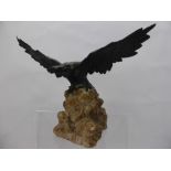 A Bronze Bird of Prey, depicted with wings outstretched, supported on a granite plinth, approx 19