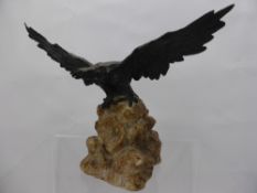 A Bronze Bird of Prey, depicted with wings outstretched, supported on a granite plinth, approx 19