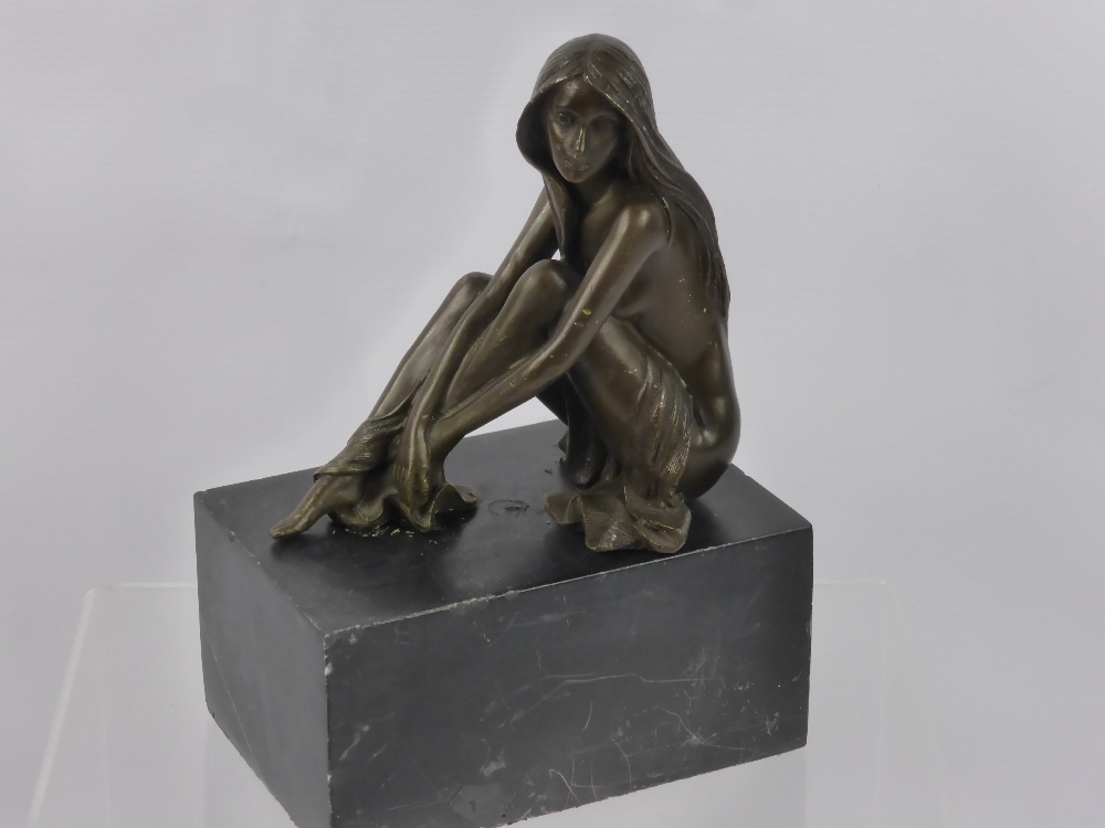 A Spelter Figure of a Young Girl, depicted seated on a marble base.