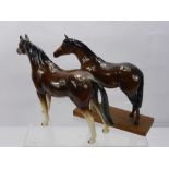 A Beswick Porcelain Figure of a Horse, together with a seated foal and two other figures of