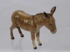 A Beswick Porcelain Figure of a Donkey.