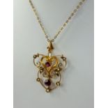 A Lady's 9 Ct Gold, Gilded Ruby and Seed Pearl Pendant, total wt 2.9 gms. 4.6 mm ruby, 3.6 mm