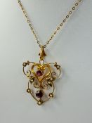 A Lady's 9 Ct Gold, Gilded Ruby and Seed Pearl Pendant, total wt 2.9 gms. 4.6 mm ruby, 3.6 mm