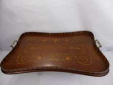 An Edwardian Inlaid Tea Tray, the scallop form tray having a floral and basket design with brass