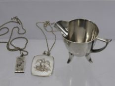 A Silver Cream Jug, Sheffield hallmark, mm H.W, together with two silver pendants on chains,