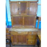 An Oak 1929 'Easiwork' Kitchen Cabinet, three top cupboards with shelves, middle cupboard with