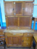 An Oak 1929 'Easiwork' Kitchen Cabinet, three top cupboards with shelves, middle cupboard with