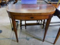 A Mahogany Card Table, on tapered legs with green baize and decorative inlay.