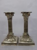 A Pair of Silver Candlesticks, modelled as Corinthian columns on square stepped loaded bases with