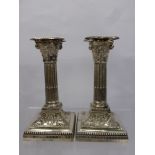 A Pair of Silver Candlesticks, modelled as Corinthian columns on square stepped loaded bases with
