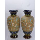 A Pair of Royal Doulton Lambeth Ware Vases, the vases having floral gilded decoration to body with