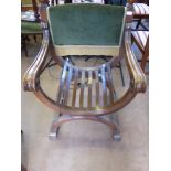 A Generously Proportioned Oak X-frame Seat with swept arms and green velvet support, possibly for