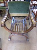 A Generously Proportioned Oak X-frame Seat with swept arms and green velvet support, possibly for