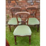 Six Mahogany Dining Chairs, on turned legs, covered in celadon upholstery.