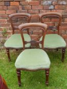 Six Mahogany Dining Chairs, on turned legs, covered in celadon upholstery.