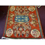 A 20th Century Persian Fine Woollen Rug, on russet background, with geometric border and eight gül