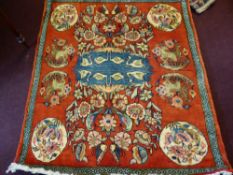 A 20th Century Persian Fine Woollen Rug, on russet background, with geometric border and eight gül