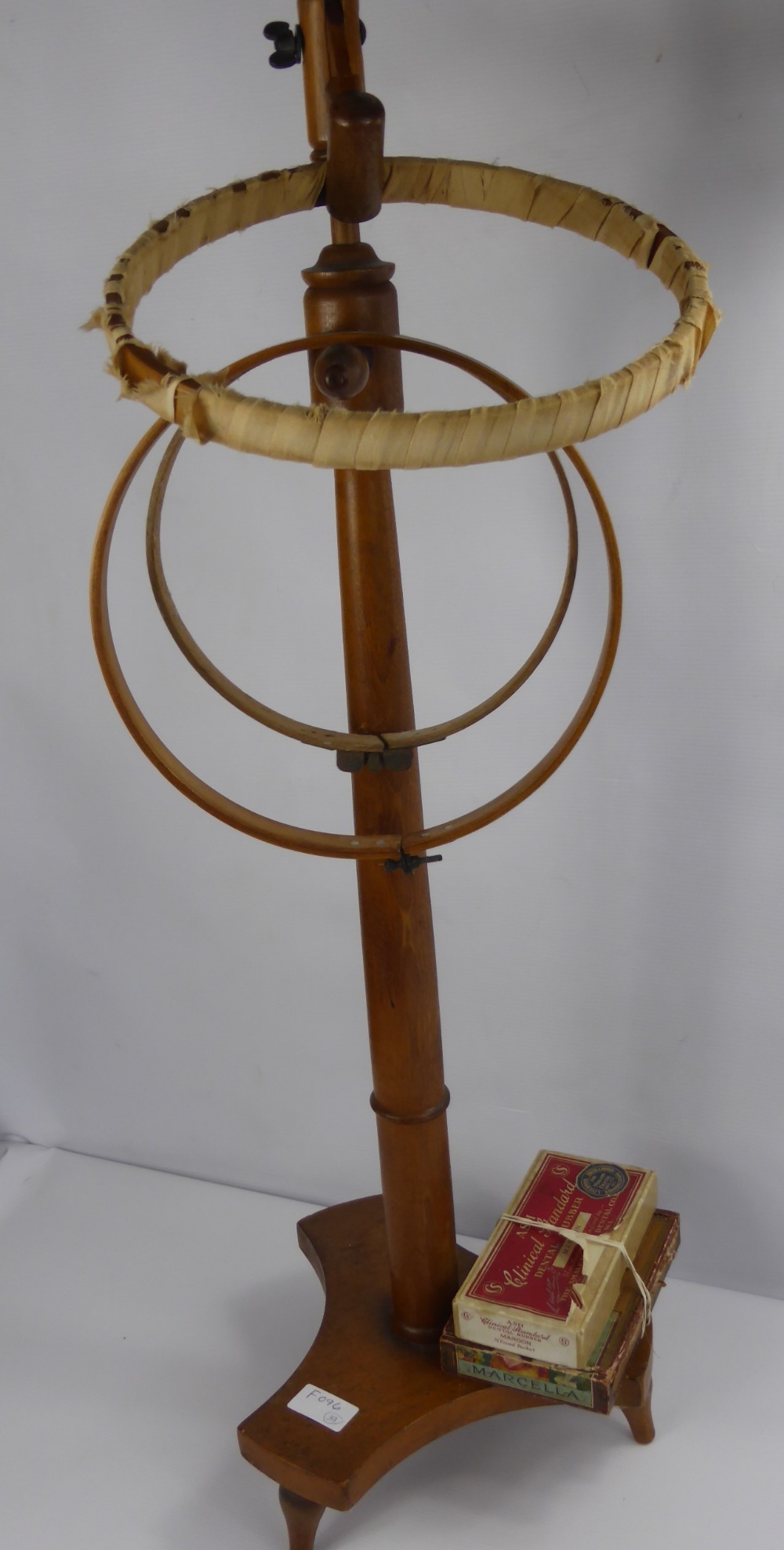 An Oak Embroidery Stand with Three Round Frames, and a quantity of crochet and tapestry needles.