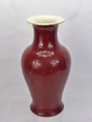 A Chinese 'Sang de Boeuf' Glazed Porcelain Vase, approx 34 cms, remnants of a label to base.
