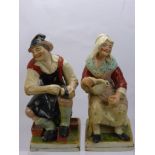 A 19th Century Staffordshire Figure of a Cobbler and his Wife, raised on square cut base, approx