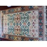 A 20th Century Turkish Woollen Kilim Rug, of geometric design in dark pink, pale pink and green,