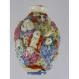 A Chinese Porcelain Hand Painted Snuff Bottle, depicting figures in high relief, with character