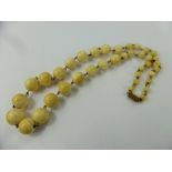 A Set of Graduated Antique Ivory Beads, on 9 ct gold links, metal clasp, approx 60 cms long, largest