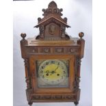 An Edwardian Continental Oak Case Mantle Clock, the clock having silvered and gold face and