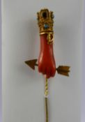 An Antique 20/22 Ct Gold, Coral, Turquoise and Garnet Stick Pin, the coral carved in the form of a