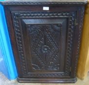 A 19th Century Stained Oak Corner Cabinet with decorative carving, approx 60 x 30 x 80 cms.