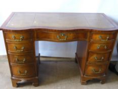 A Reproduction Serpentine Front Mahogany Twin Pedestal Desk, the desk having central drawer with