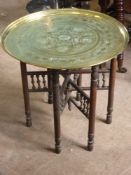 An Indian Brass Topped Coffee Table, depicting elephants.