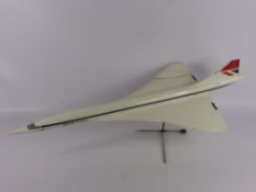 A Wooden Model of British Airways Concorde, supported on chrome stand, approx 83 x 36 cms.