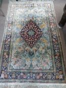 A Fine Woollen Persian Rug, with floral and bird design in pink, green and pink tulip design on blue