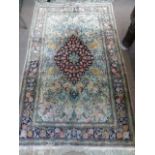 A Fine Woollen Persian Rug, with floral and bird design in pink, green and pink tulip design on blue