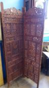 A Four Panel Carved Wooden Screen, the screen depicting vine leaves, approx 184 x 200 cms.