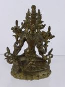 An Antique Sino-Tibetan Gilt Bronze Figure of Buddha, seated on a lotus dias, with hand raised in