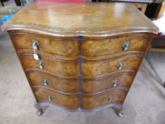 A Walnut Chest of Drawers, four graduated drawers on bracket feet, with brass drop handles.