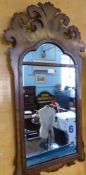 An Antique Chippendale Style Walnut Veneer Mirror, the mirror having a plumed top with carved