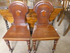 A Pair of Mahogany Victorian Shield Back Hall Chairs.