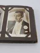 A Vintage Album of Screen Stars Photographs, some signed, including Ginger Rogers, Fred Astaire,