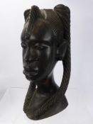 An African Hard Wood Figure of a Woman, with plaited hair, approx 31 cms high.