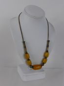 A Lady's Amber Tribal Style Necklace, on silver mesh chain with tubular decoration, approx 45 cms