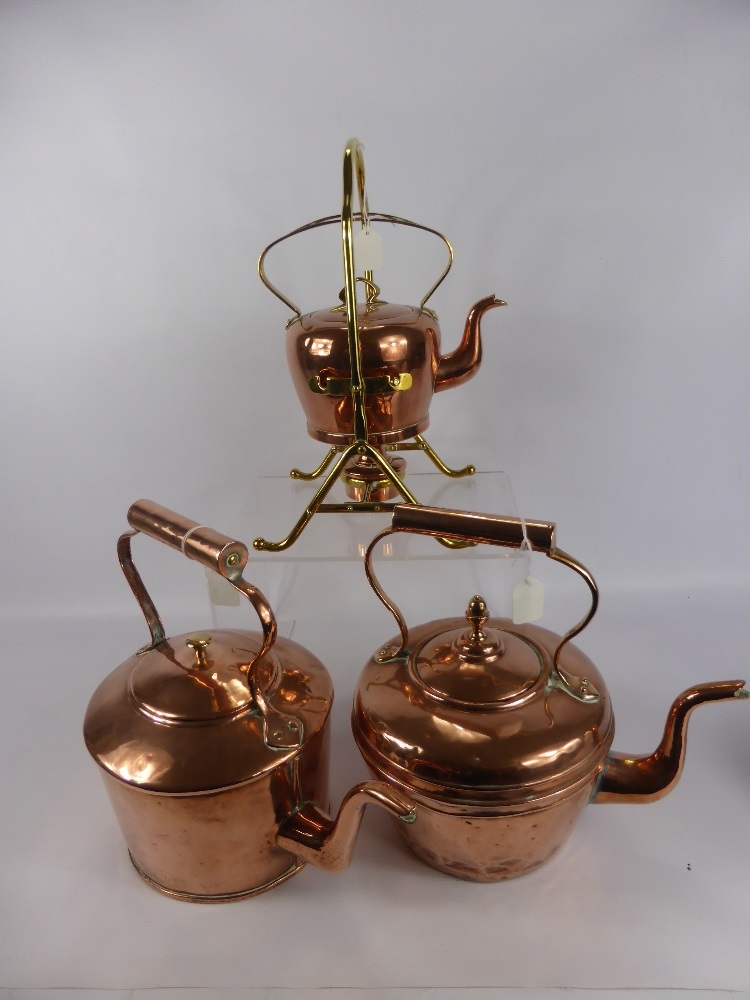 Two Antique Copper Kettles, together with a copper and brass spirit kettle.