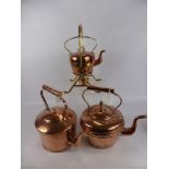 Two Antique Copper Kettles, together with a copper and brass spirit kettle.