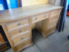 A Pine Desk, four graduated drawers to each side, one central drawer, supported on bracket feet,