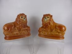 A Pair of Victorian Pottery Lions, with glass eyes. (wf)