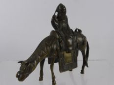 A Chinese Antique Bronze Horse, with a mounted figure dressed in long robes, seated side saddle, the