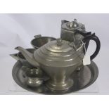 A Hammered Pewter Tea Set, in the Tudric style, comprising tea pot, sugar bowl, creamer, tea