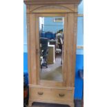 A Vintage Pine Wardrobe, the wardrobe having a mirrored door with drawer below, on raised feet,